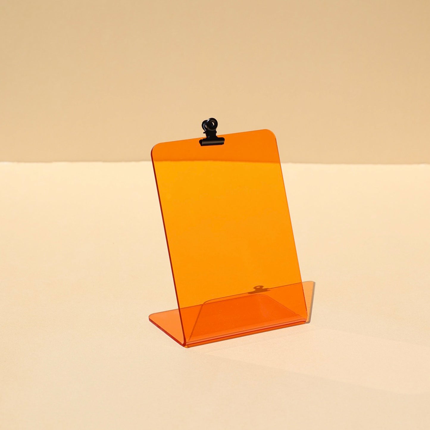 Orange display stand with metal clip for postcards or visual aids