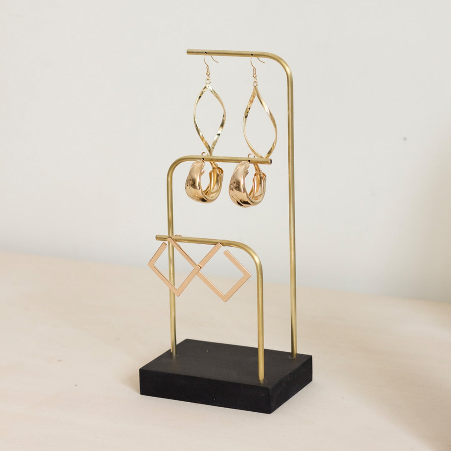 Black and gold earring holder by Makk Design