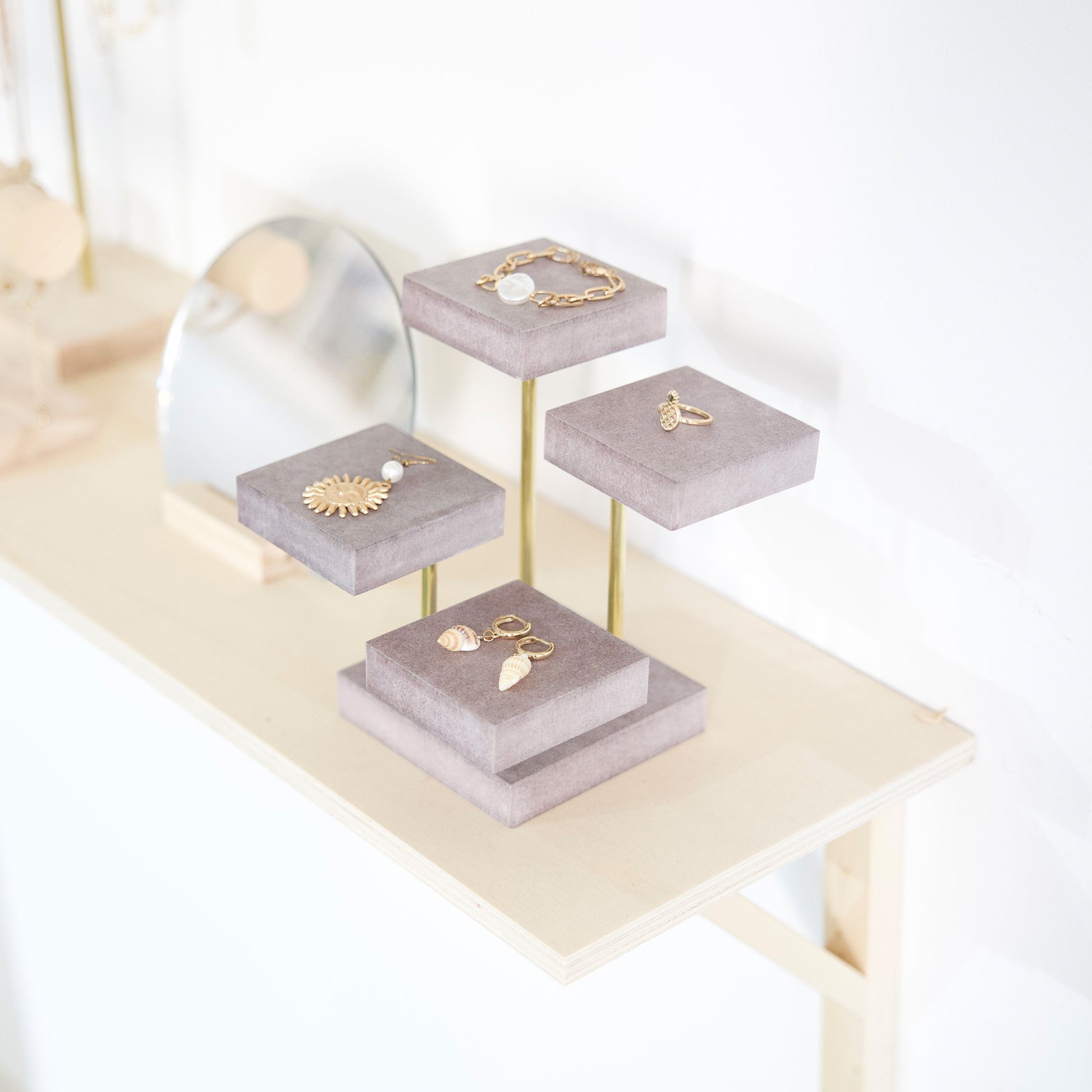 Gray and gold wooden jewelry display for stores